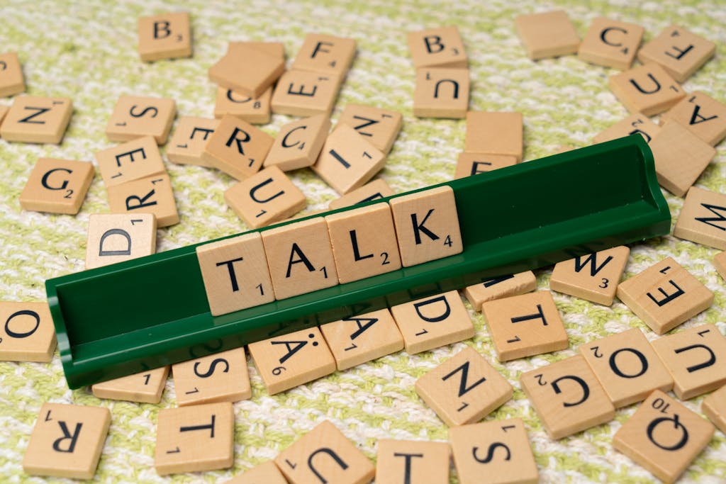 The word talk is spelled out with scrabble tiles